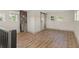 Bedroom featuring a sliding barn door, exposed brick, and wood laminate flooring at 100 E Fern St, Tampa, FL 33604