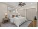 Bright bedroom with large windows, a comfortable bed, soft lighting, and ample closet space at 100 E Fern St, Tampa, FL 33604