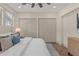 Bedroom featuring a neutral color palette, white bedding, and large closets at 100 E Fern St, Tampa, FL 33604