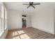 Bedroom with ceiling fan and a view of the kitchen through doorway at 100 E Fern St, Tampa, FL 33604
