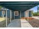 Carport leading to a blue house with manicured landscaping and a charming entrance at 100 E Fern St, Tampa, FL 33604