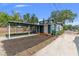 Inviting blue house featuring a convenient carport and landscaped yard at 100 E Fern St, Tampa, FL 33604