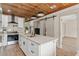Modern kitchen featuring white cabinets, stainless steel appliances, and large island at 100 E Fern St, Tampa, FL 33604