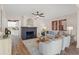 Spacious living room with neutral color palette, fireplace, and updated kitchen in background at 100 E Fern St, Tampa, FL 33604