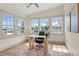 Bright office space with large windows, modern desk, and hardwood floors at 100 E Fern St, Tampa, FL 33604