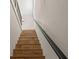 Stairway with wood steps, metal railing, and natural light from a window at 100 E Fern St, Tampa, FL 33604