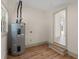 Utility room featuring a water heater and gray trim at 100 E Fern St, Tampa, FL 33604