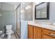 Bathroom with glass enclosed shower, granite countertop, and neutral tile flooring at 102 S Moody Ave # 1, Tampa, FL 33609