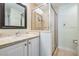 Bathroom with granite counters, single vanity, glass shower, and tile floor at 102 S Moody Ave # 1, Tampa, FL 33609