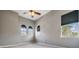 Bright bedroom with three arched windows, plush carpet, and a ceiling fan at 102 S Moody Ave # 1, Tampa, FL 33609
