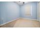 Cozy bedroom with light blue walls, carpet flooring, and natural light from the window at 102 S Moody Ave # 1, Tampa, FL 33609