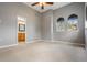 Spacious bedroom with arched windows, neutral carpet, and an ensuite bathroom at 102 S Moody Ave # 1, Tampa, FL 33609