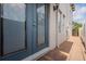 Side exterior view showing the back door, landscaping and a portion of the building at 102 S Moody Ave # 1, Tampa, FL 33609