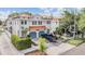 A two story home with terracotta tile roof, blue garages and lush landscaping at 102 S Moody Ave # 1, Tampa, FL 33609