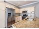 Contemporary kitchen with granite countertops, stainless appliances, and white cabinetry at 102 S Moody Ave # 1, Tampa, FL 33609