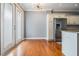 Cozy kitchen area with stainless steel refrigerator, double doors with view, and hardwood floors at 102 S Moody Ave # 1, Tampa, FL 33609