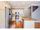 Modern kitchen with stainless steel appliances, granite countertop, subway tile backsplash, and hardwood floors at 102 S Moody Ave # 1, Tampa, FL 33609