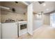 Bright laundry room featuring a modern washer and dryer with a shelf for storage at 102 S Moody Ave # 1, Tampa, FL 33609