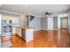 Spacious living room featuring hardwood floors, a kitchen island, and stainless steel appliances at 102 S Moody Ave # 1, Tampa, FL 33609