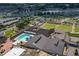 Community recreation area with swimming pool, sports lawns and surrounding buildings at 1111 Jasmine Creek Ct, Sun City Center, FL 33573