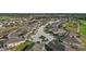 A wide-angle aerial photo of a residential neighborhood that features tree-lined streets and well-maintained landscaping at 1111 Jasmine Creek Ct, Sun City Center, FL 33573