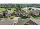 Aerial view of a home with well-maintained landscaping, tile roof, near a pond and golf course at 1111 Jasmine Creek Ct, Sun City Center, FL 33573