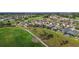 Panoramic aerial view of a residential neighborhood with a golf course and a tranquil lake, ideal for active living at 1111 Jasmine Creek Ct, Sun City Center, FL 33573
