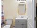 Compact bathroom featuring a gray vanity, modern fixtures, and a neutral color scheme at 1111 Jasmine Creek Ct, Sun City Center, FL 33573