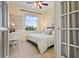 Cozy bedroom with neutral walls, a ceiling fan, and a window with natural light at 1111 Jasmine Creek Ct, Sun City Center, FL 33573