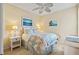 Cozy bedroom with beach-themed decor, a ceiling fan, and a comfortable bed at 1111 Jasmine Creek Ct, Sun City Center, FL 33573
