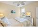 Cozy bedroom with a white ceiling fan, comfortable bed, and white dresser with matching mirror at 1111 Jasmine Creek Ct, Sun City Center, FL 33573