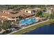 Resort-style community pool and clubhouse overlooking a scenic lake, perfect for relaxation and social gatherings at 1111 Jasmine Creek Ct, Sun City Center, FL 33573