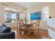 Dining room featuring hardwood floors, chandelier, and large windows overlooking the pool at 1111 Jasmine Creek Ct, Sun City Center, FL 33573