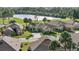 Beautiful single-story home with a well-manicured lawn and tropical landscaping near a lake and golf course at 1111 Jasmine Creek Ct, Sun City Center, FL 33573