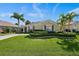Charming one-story home featuring a well-kept lawn, lush landscaping, and a welcoming driveway at 1111 Jasmine Creek Ct, Sun City Center, FL 33573
