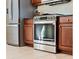Kitchen with stainless steel oven and refrigerator and dark wood cabinets at 1111 Jasmine Creek Ct, Sun City Center, FL 33573