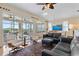 Bright and airy living room with large windows overlooking the pool area, featuring hardwood floors and stylish furnishings at 1111 Jasmine Creek Ct, Sun City Center, FL 33573
