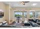 Bright living room with modern furnishings, hardwood floors, and sliding glass doors to outdoor pool area at 1111 Jasmine Creek Ct, Sun City Center, FL 33573