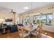 Open concept living and dining area with hardwood floors and sliding glass doors to outdoor living at 1111 Jasmine Creek Ct, Sun City Center, FL 33573