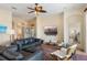 Cozy living room featuring comfortable seating, a ceiling fan, and an entertainment center, creating a relaxing atmosphere at 1111 Jasmine Creek Ct, Sun City Center, FL 33573