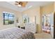 Main bedroom with natural light, view of the outside, dresser, and ensuite bathroom at 1111 Jasmine Creek Ct, Sun City Center, FL 33573