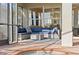 Covered patio with comfortable outdoor seating overlooking the pool, offering a relaxing and inviting entertainment space at 1111 Jasmine Creek Ct, Sun City Center, FL 33573