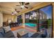 Outdoor living space with comfortable seating, dining area and pool beyond, perfect for outdoor relaxation and entertainment at 1111 Jasmine Creek Ct, Sun City Center, FL 33573