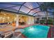 Screened pool area with outdoor dining and lounge seating, perfect for relaxing and entertaining by the pool at 1111 Jasmine Creek Ct, Sun City Center, FL 33573