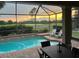 Inviting screened-in pool area with sunset views over the golf course; perfect for relaxation and entertaining at 1111 Jasmine Creek Ct, Sun City Center, FL 33573