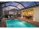Inviting screened-in pool and patio area perfect for outdoor dining and lounging with serene backyard views at 1111 Jasmine Creek Ct, Sun City Center, FL 33573
