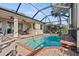 Screened-in backyard pool with brick pavers, a covered patio, and well-maintained landscaping at 1111 Jasmine Creek Ct, Sun City Center, FL 33573