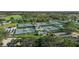 Aerial shot of tennis courts, showing recreational facilities in a beautiful community surrounded by lush landscaping at 1111 Jasmine Creek Ct, Sun City Center, FL 33573