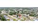 Expansive aerial view of a home nestled in a tranquil neighborhood with lush greenery and mature trees at 11123 Thornberry Dr, Spring Hill, FL 34609