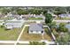 Aerial view of a single-Gathering home with solar panels, surrounded by a well-maintained yard and white fence at 11123 Thornberry Dr, Spring Hill, FL 34609